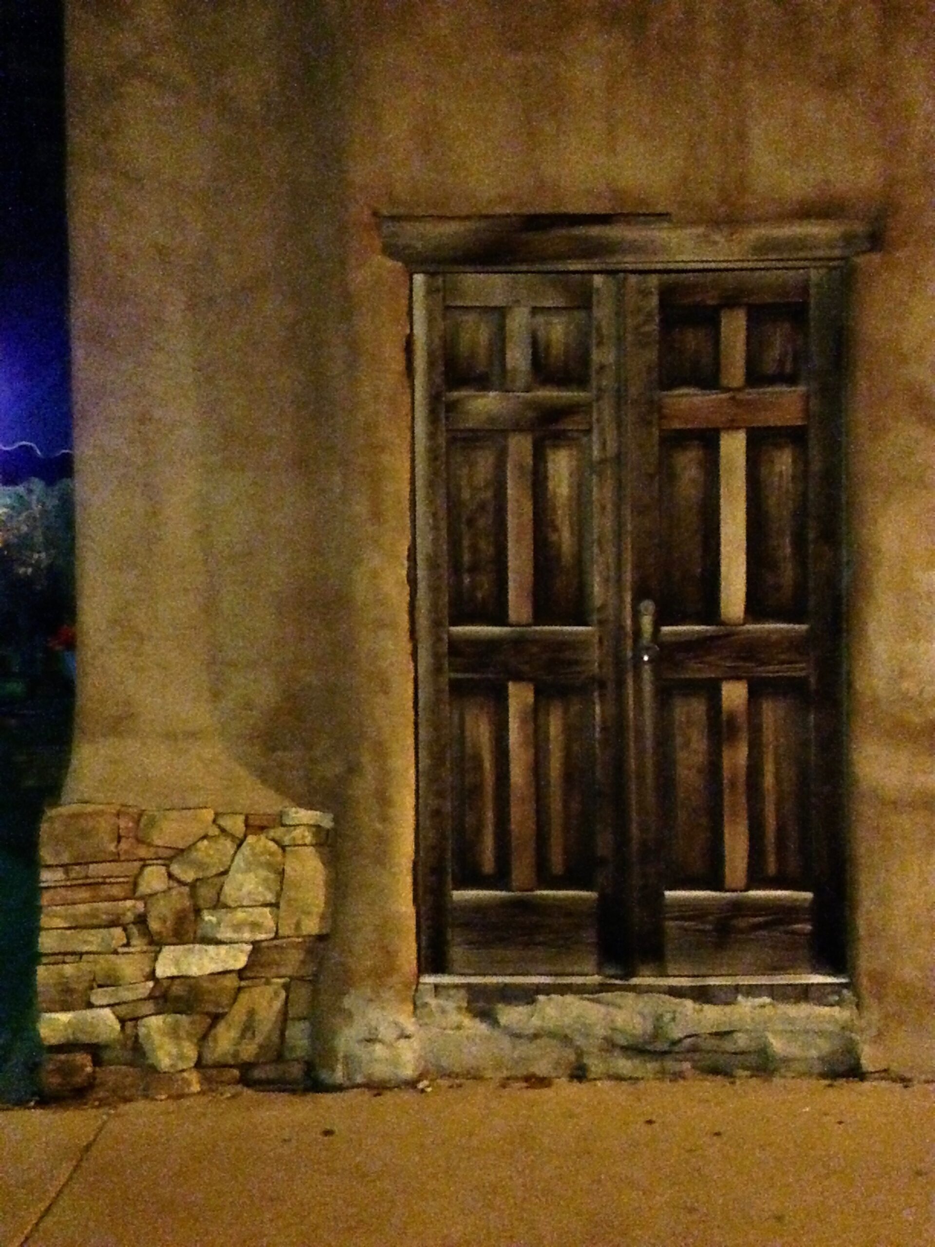 An adobe door at night in santa fe, new mexico.