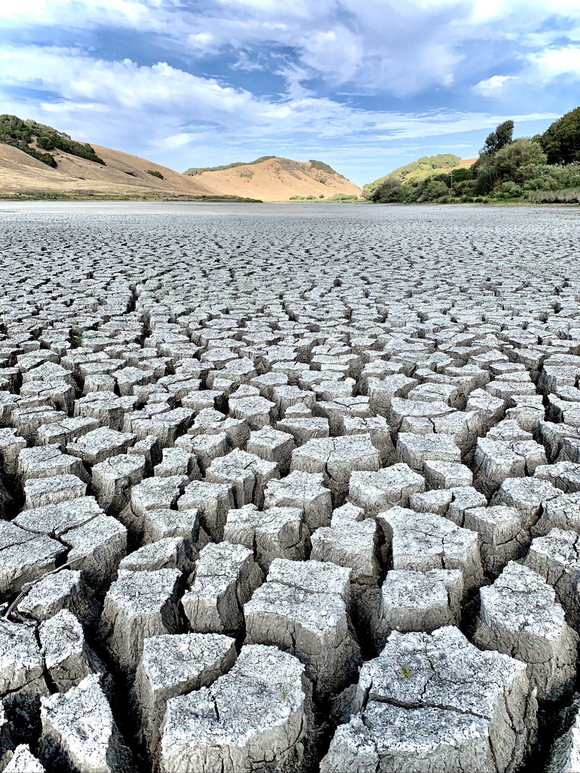 A dry lake with cracks in it.