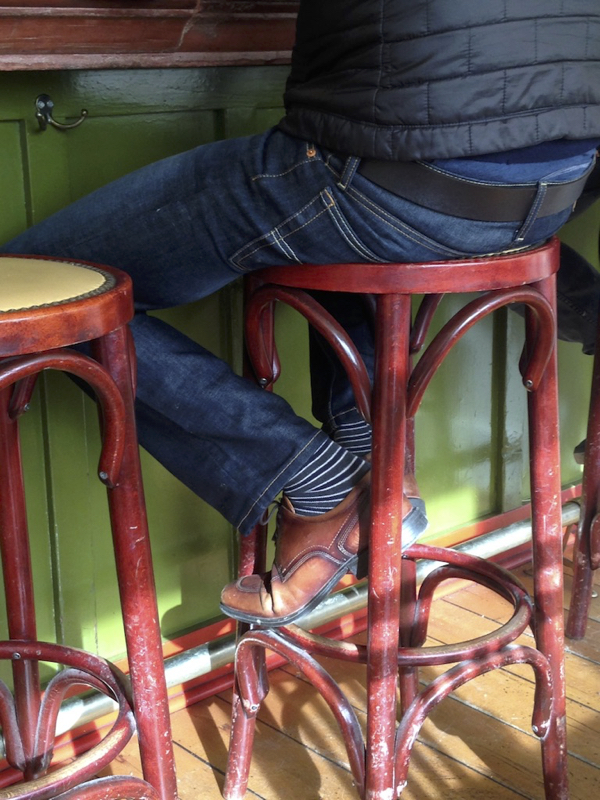 A person sitting on a bar stool.