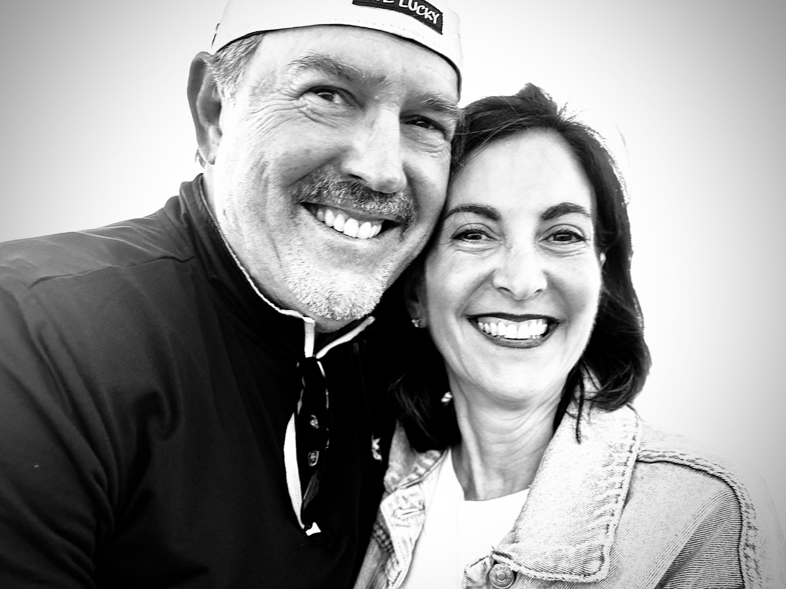 A black and white photo of a man and woman smiling.