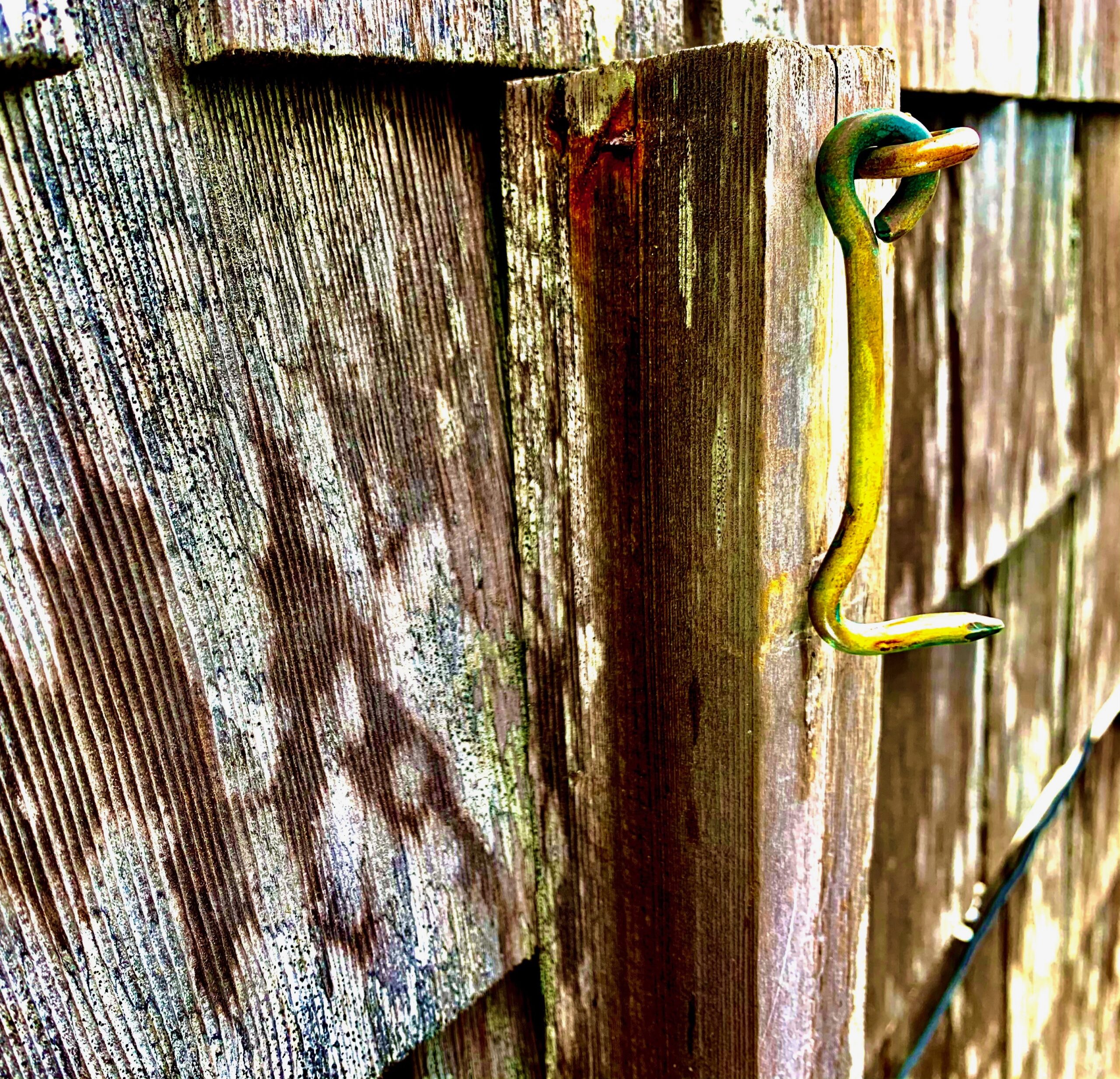 A hook on the side of a wooden wall.
