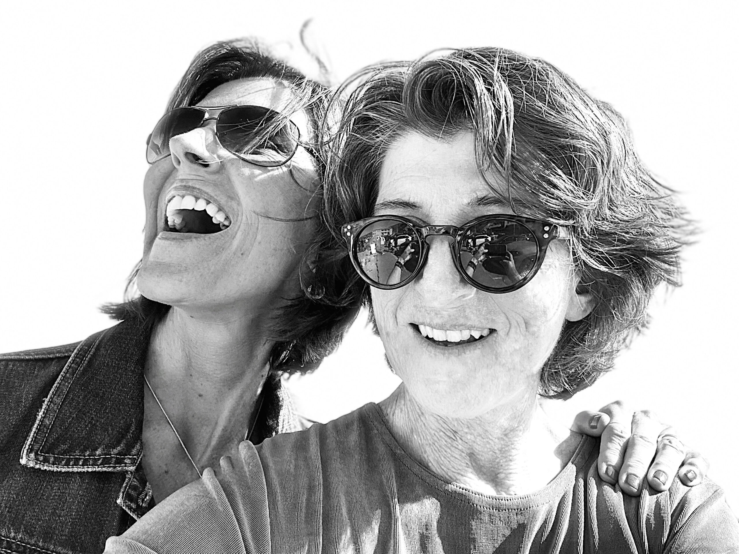 Black and white photo of two women with sunglasses.